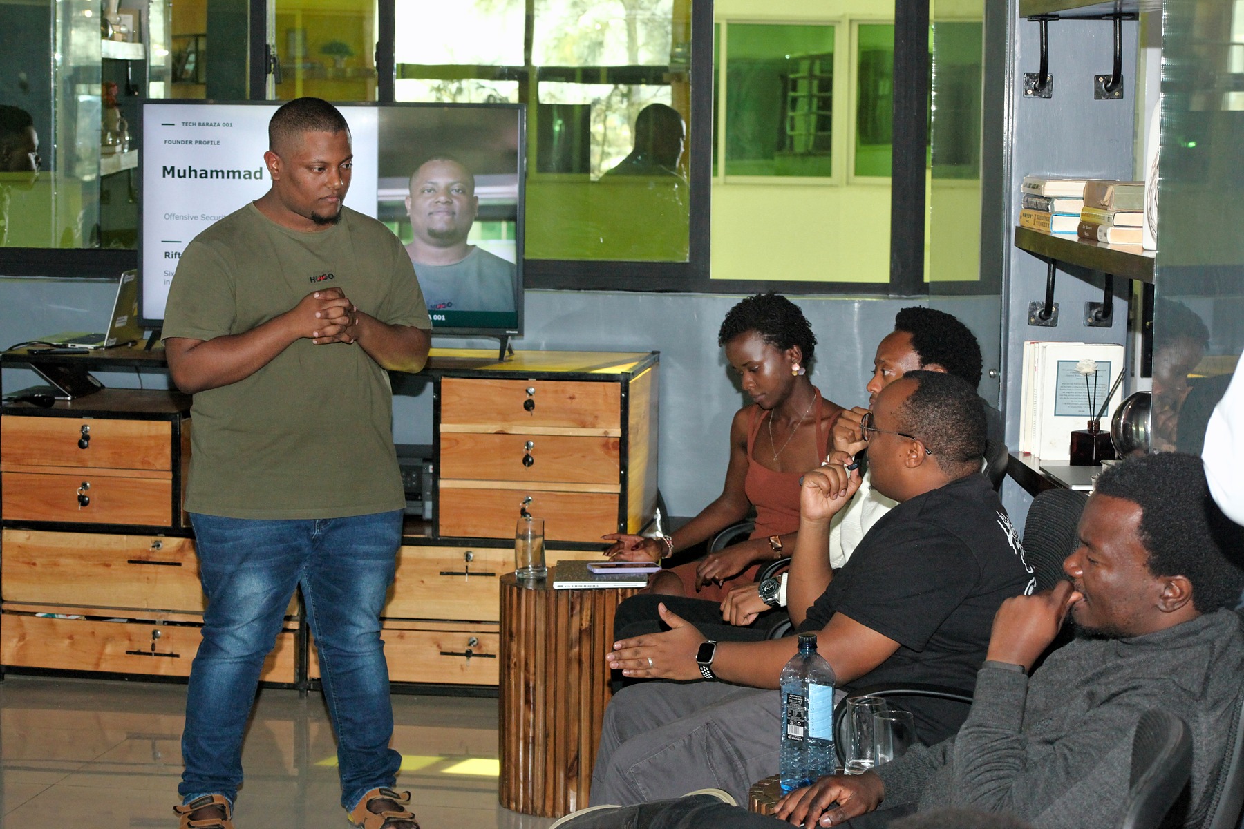 A man presenting to a small seated group