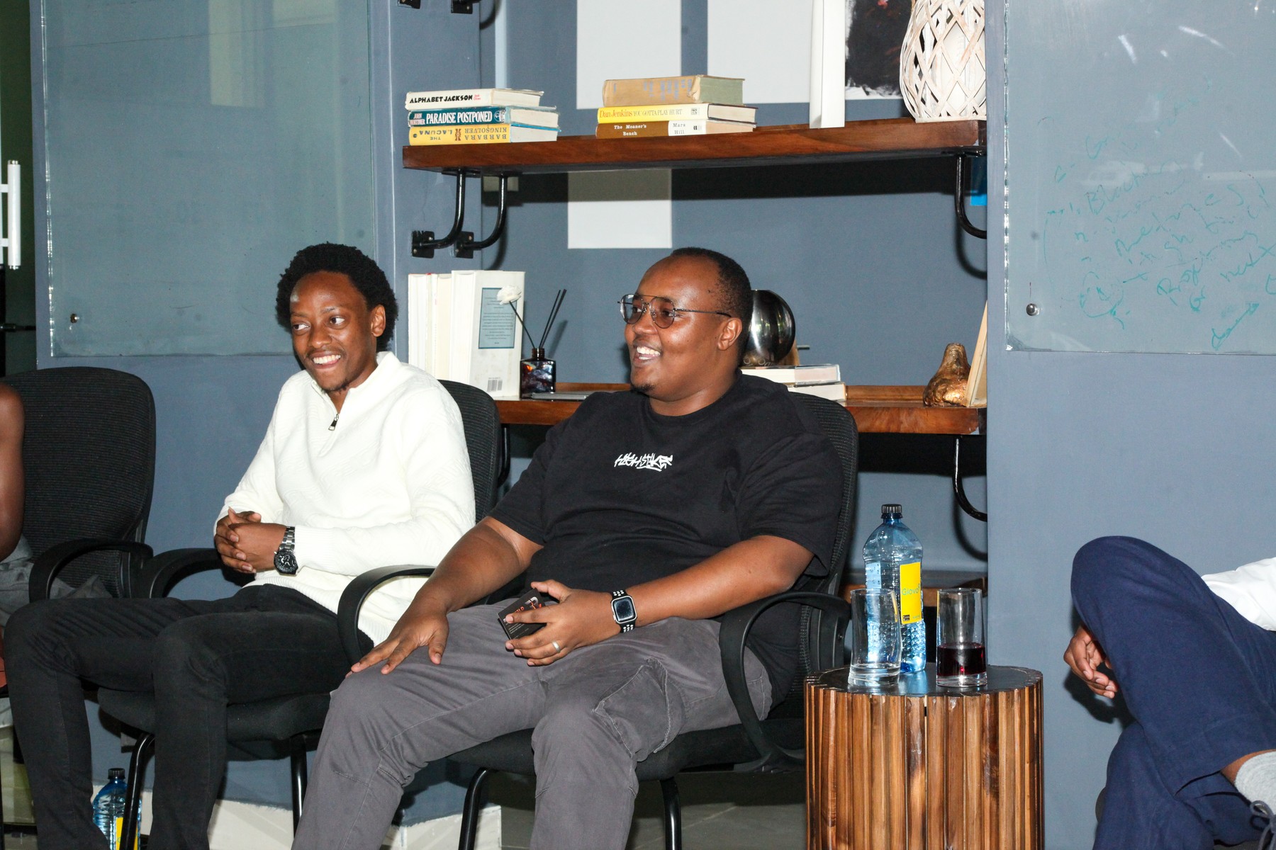 Two people laughing as they sit with the group